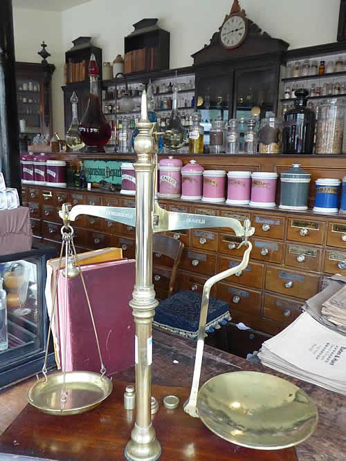 Chemist counter with scales, wooden drawers and ceramic containers at Blists Hill Museum, Ironbridge